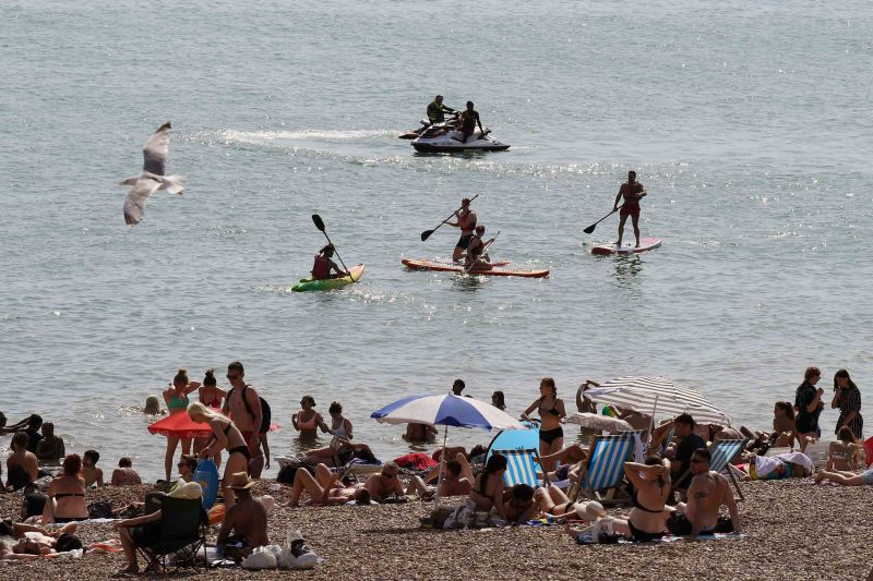 Many flocked to the beach to cool down in Brighton, southern England on Tuesday. 